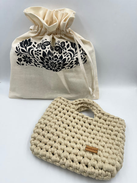 Bolsa de mano en tono arena.